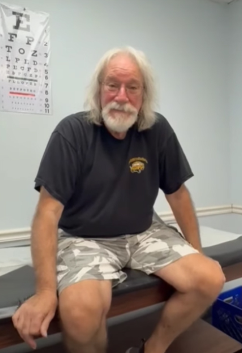 Patient seated in clinic exam room
